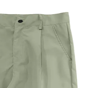 Detailed macro view of the waistband and side pocket on men's sage green cargo pants
