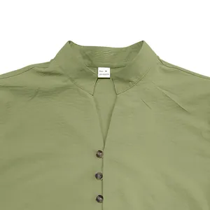 Close-up of olive green men's casual shirt collar with three buttons and Size M tag.
