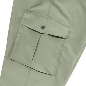 Close-up detail of cargo pocket on sage green men's trousers with silver snap button