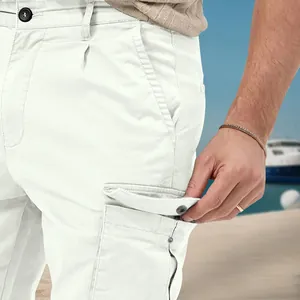 Close-up detail of side cargo pocket with button flap on men's white leisure pants