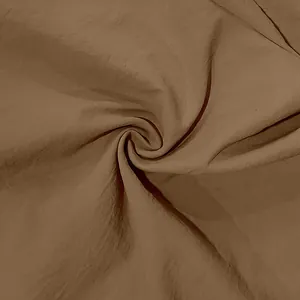 Macro detail showing the soft texture and weave of brown linen shirt fabric