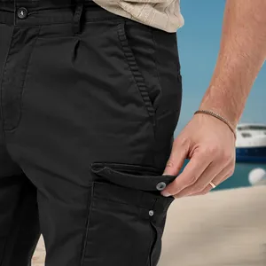 Detail view of black men's cargo pants showing side flap pocket and fabric texture