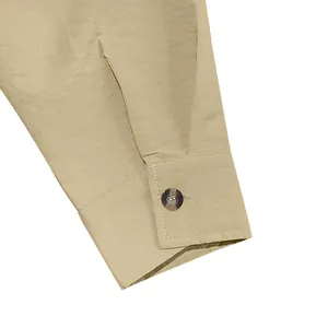 Detail shot of men's linen casual shirt cuff with button and textured fabric finish.