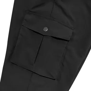 Close-up detail of cargo pocket with metal snap button on black pants