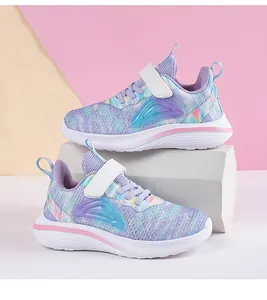 Detailed view of breathable purple mesh girls' running shoes on colorful background
