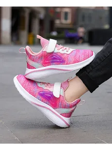 Close-up side view of pink breathable mesh sneakers for girls with durable white soles