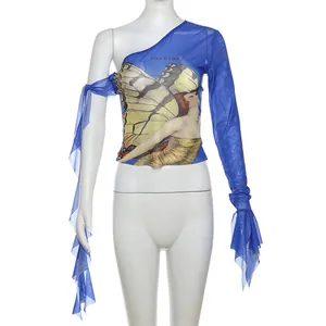 Detailed view of blue one-shoulder mesh top with artistic butterfly print and ribbons.