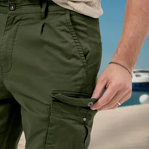 Close-up of olive green cargo pants featuring durable pockets and high-quality fabric detail.