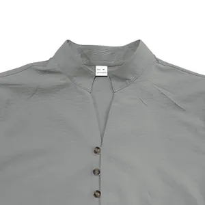 Close-up detail of a men's grey stand collar casual shirt with button-up placket texture
