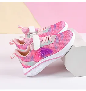 Side view of lightweight pink mesh girls' sneakers with breathable fabric and Velcro straps.