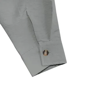 Close-up detail of a men's vintage linen shirt cuff with crinkled fabric and button
