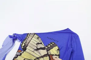 Close-up of blue one-shoulder mesh top with butterfly and portrait print