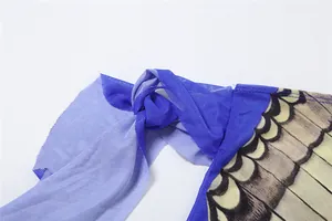 Detail of blue mesh fabric with knot and butterfly wing print on a slim-fit T-shirt.