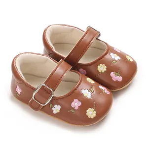 Detailansicht brauner Baby-Mary-Janes für Mädchen mit einer zarten Blumenstickerei.
