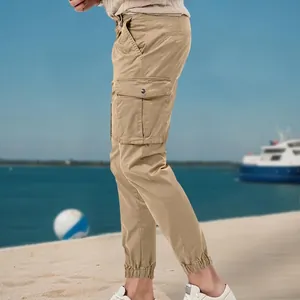 Detailed side view of khaki men's cargo pants featuring large side pockets and elastic cuffs
