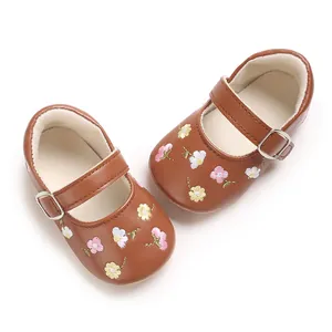 Draufsicht auf braune Babyschuhe für Mädchen mit feiner rosa Blumenstickerei