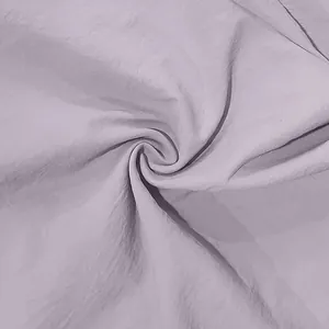 Macro view showing the soft lavender linen fabric texture of the men's casual shirt