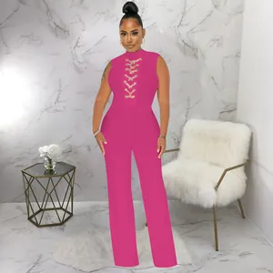 Detail of a bright pink sleeveless wide-leg jumpsuit with elegant lace-up chest design.
