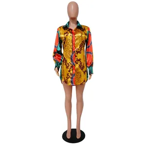 Vibrant baroque print long-sleeved loose shirt dress presented on a mannequin stand