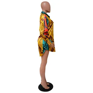 Side view of a vibrant baroque print long-sleeved shirt dress with smooth satin finish