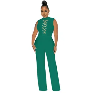 Emerald green sleeveless wide-leg jumpsuit featuring gold lace-up eyelet chest detail.