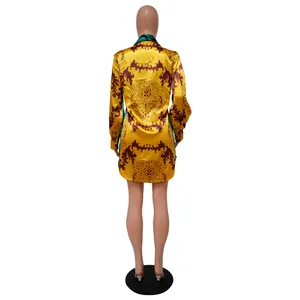 Rear view detail of a vibrant yellow baroque print long sleeve satin shirt dress for women