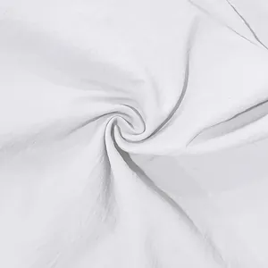 Close-up macro detail of white breathable linen fabric texture with spiral fold