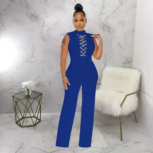 Sleeveless high neck blue jumpsuit featuring lace-up chain detail and wide leg design