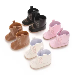 Close-up of baby cowboy boots in multiple colors featuring decorative embroidery details