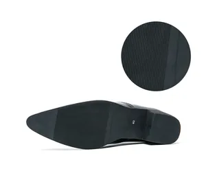 Close-up detail of the anti-slip rubber sole on a men's pointed toe leather shoe
