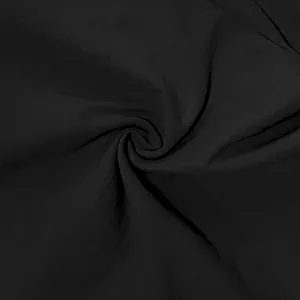 Close-up macro view of high-quality black linen fabric texture with spiral folding