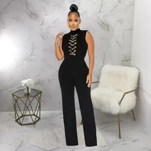 Detailed view of a sexy sleeveless black jumpsuit with gold chain lace-up and wide-leg design.