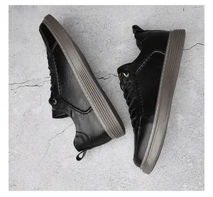 Top-down view showing the fine leather texture and grooved soles of black vintage sneakers