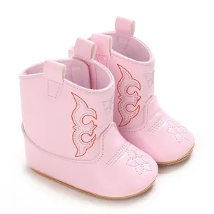 Close-up of pink baby cowboy boots with orange embroidery and soft non-slip PU soles