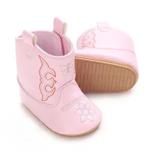 Detail view of soft pink PU leather baby cowboy boots with embroidery and non-slip sole.