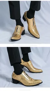 Close-up view of shiny gold pointed-toe men's dress shoes with a front zipper.