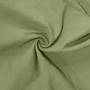 Close-up of breathable light green linen fabric texture for men's summer shirt