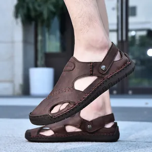 Close-up view of men's brown leather outdoor sandals with a breathable hollow design.