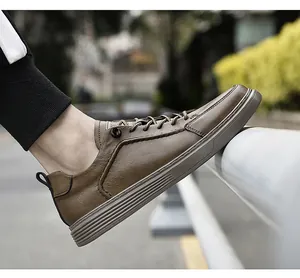 Close-up of men's vintage brown leather sneakers worn in an outdoor city setting