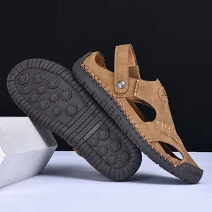Close-up of brown leather men's sandals showing non-slip rubber sole and side texture
