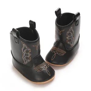 Close-up of black PU baby cowboy boots with intricate western style embroidery detail.