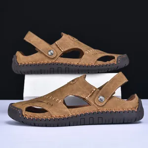 Close-up of brown leather men's sandals with hand-stitched details and thick soles
