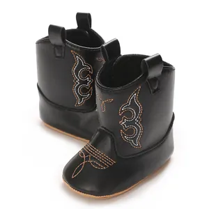 Detail shot of black soft PU leather baby cowboy boots with western style decorative stitching