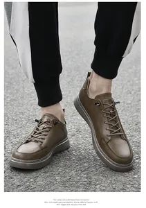 Detail view of brown retro leather casual shoes for men on asphalt road