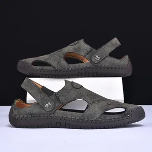 Close-up of men's leather sandals with hand-stitched detailing and convertible strap.
