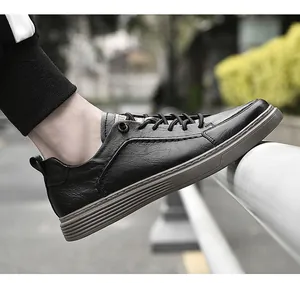 Detailed side view of men's black leather casual shoes featuring grey textured soles