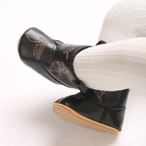 Detail view of black embroidered soft-sole infant boots with non-slip bottom
