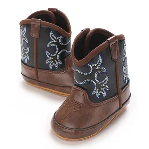 Vue détaillée de la broderie et du cuir souple des bottes western pour bébés.