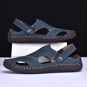 Side view detail of blue men's leather hybrid sandals with white contrast stitching.