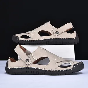 Side view of beige leather men's sandals with hand-stitched detailing and black rubber sole